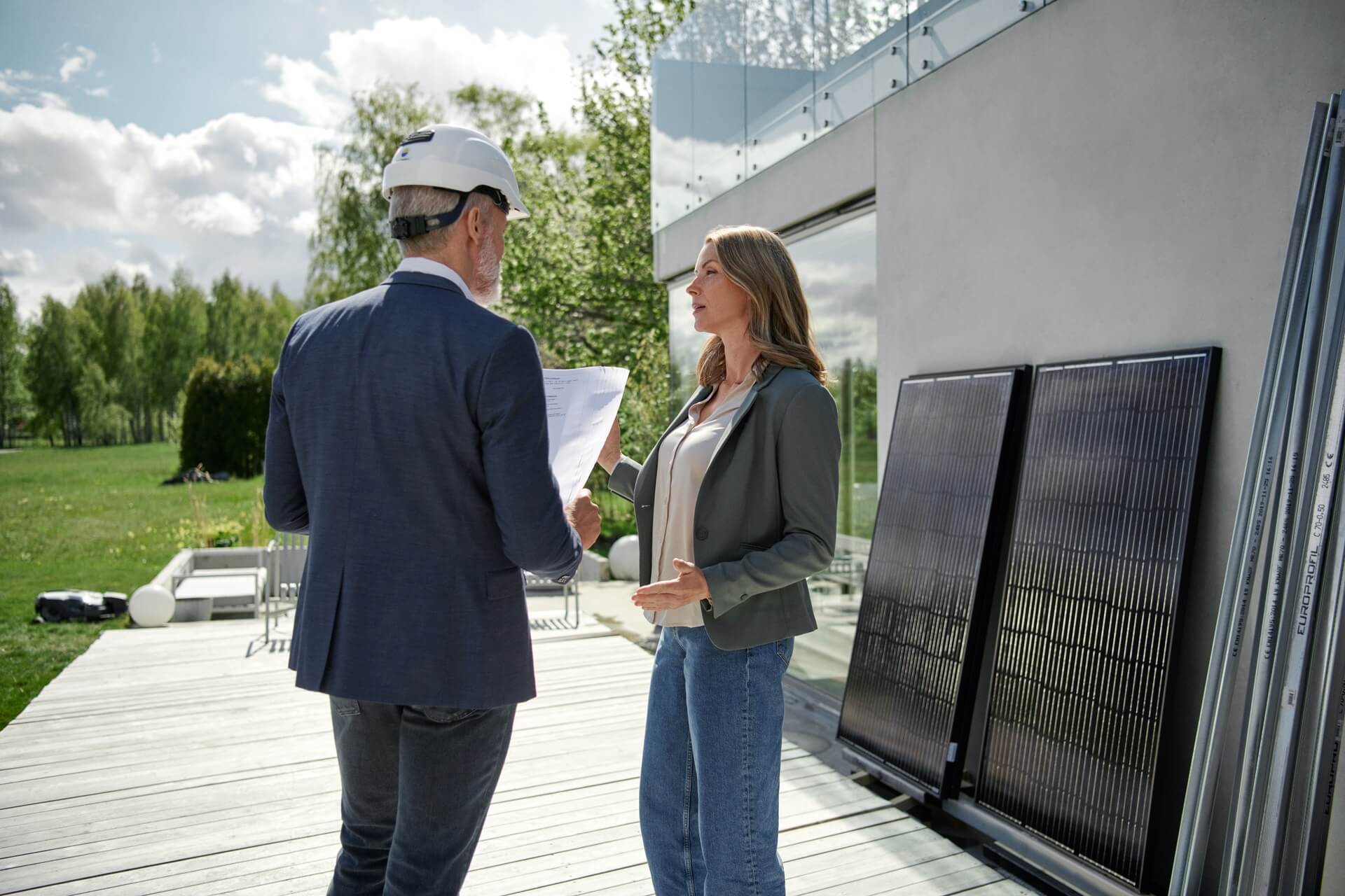 Zonnepanelen zakelijk adviseur in gesprek met vrouw over keuze zonnepanelen