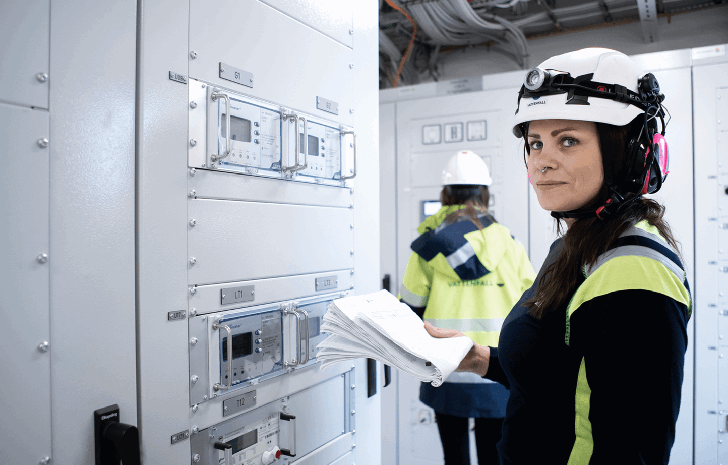 Vrouw met helm in elektriciteitscentrale