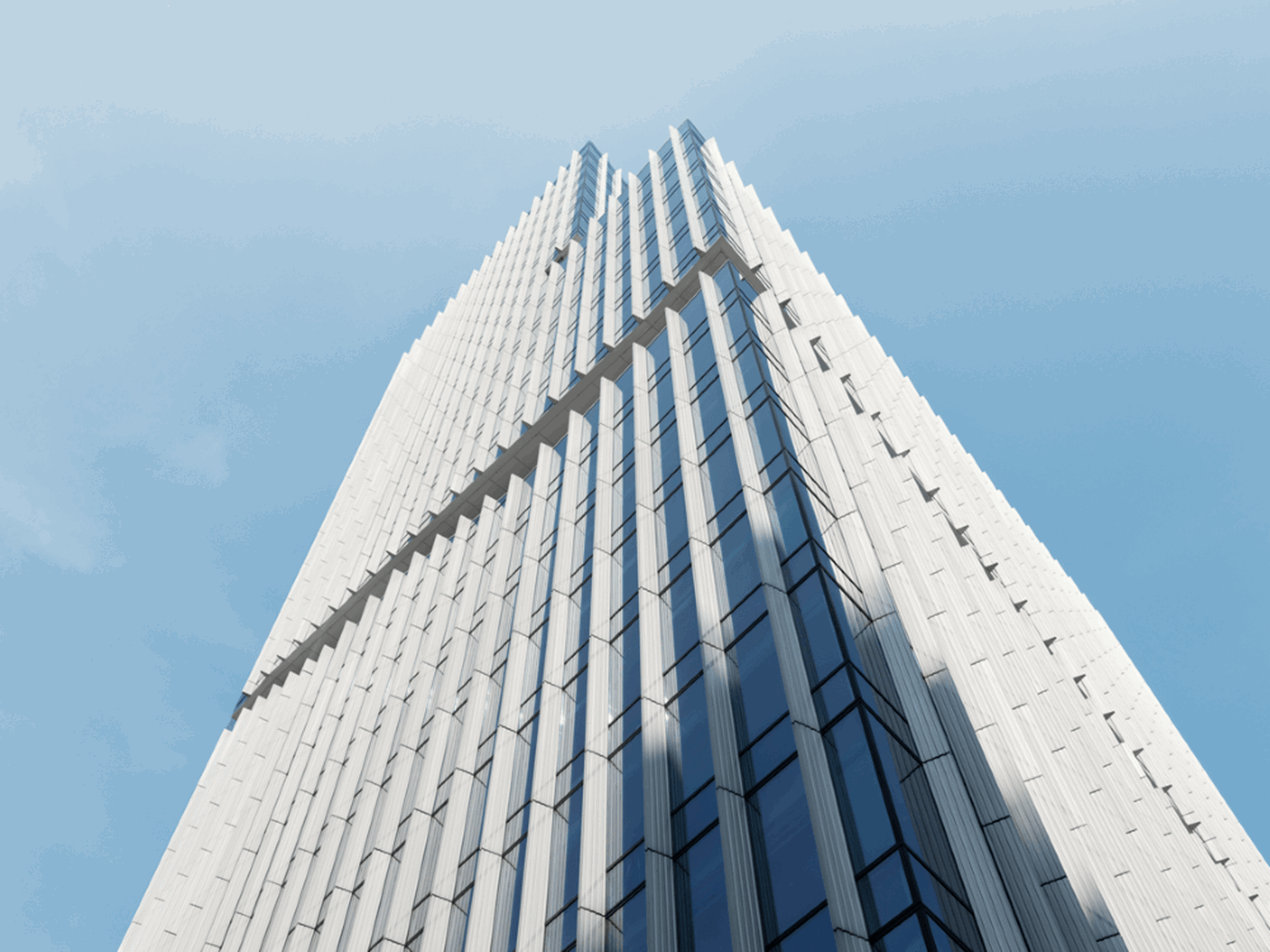 Foto van groot kantoorgebouw tegen een blauwe lucht