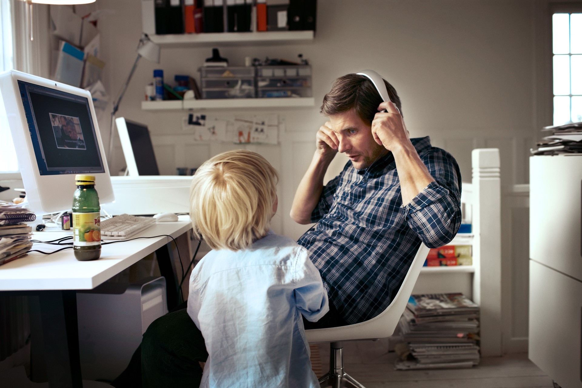 Jonge vader in zijn werkkamer luistert muziek met zijn zoontje | Vattenfall Energielabel F