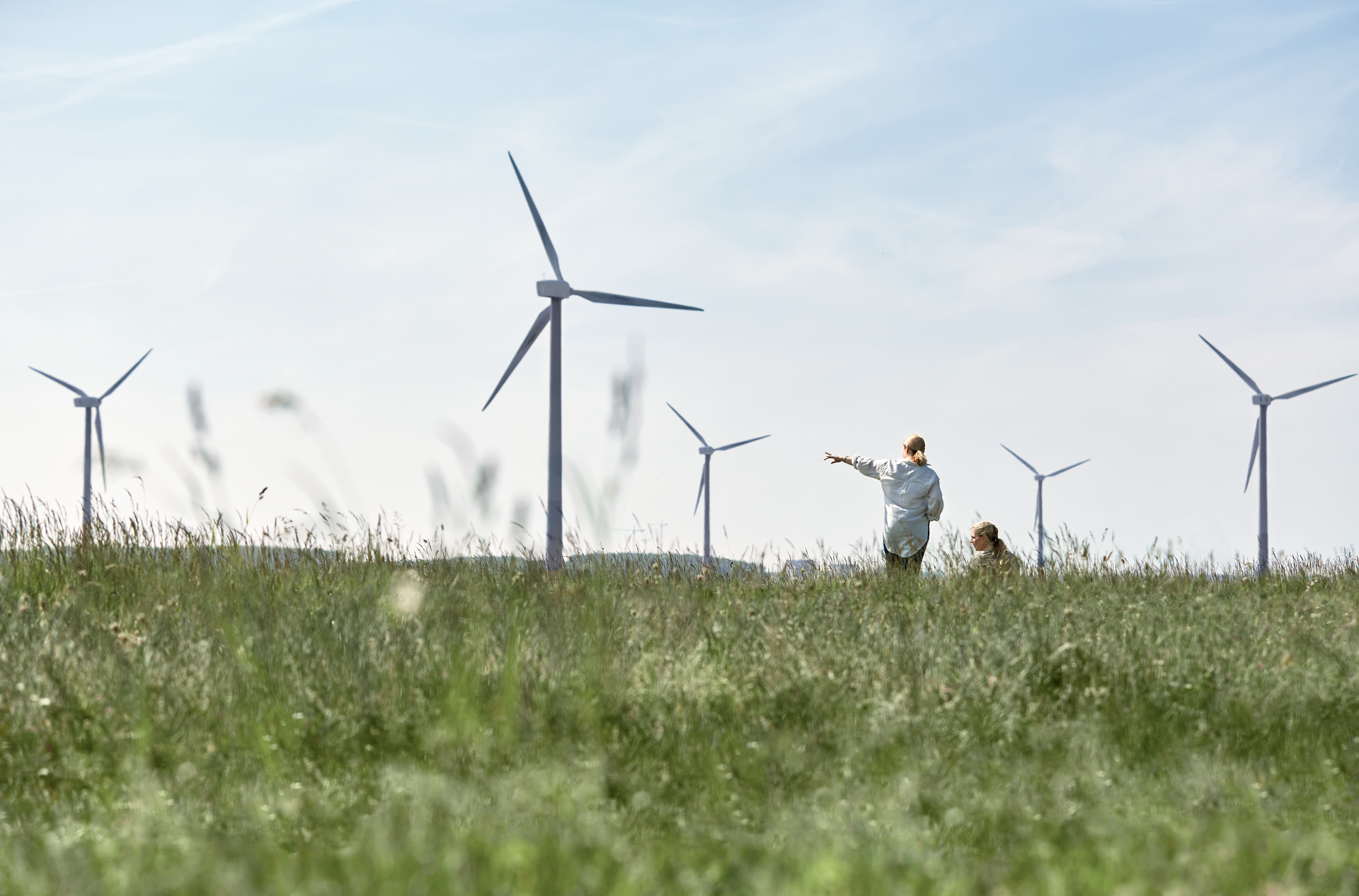 Twee vrouwen in weiland met windmolens | Vattenfall over energie